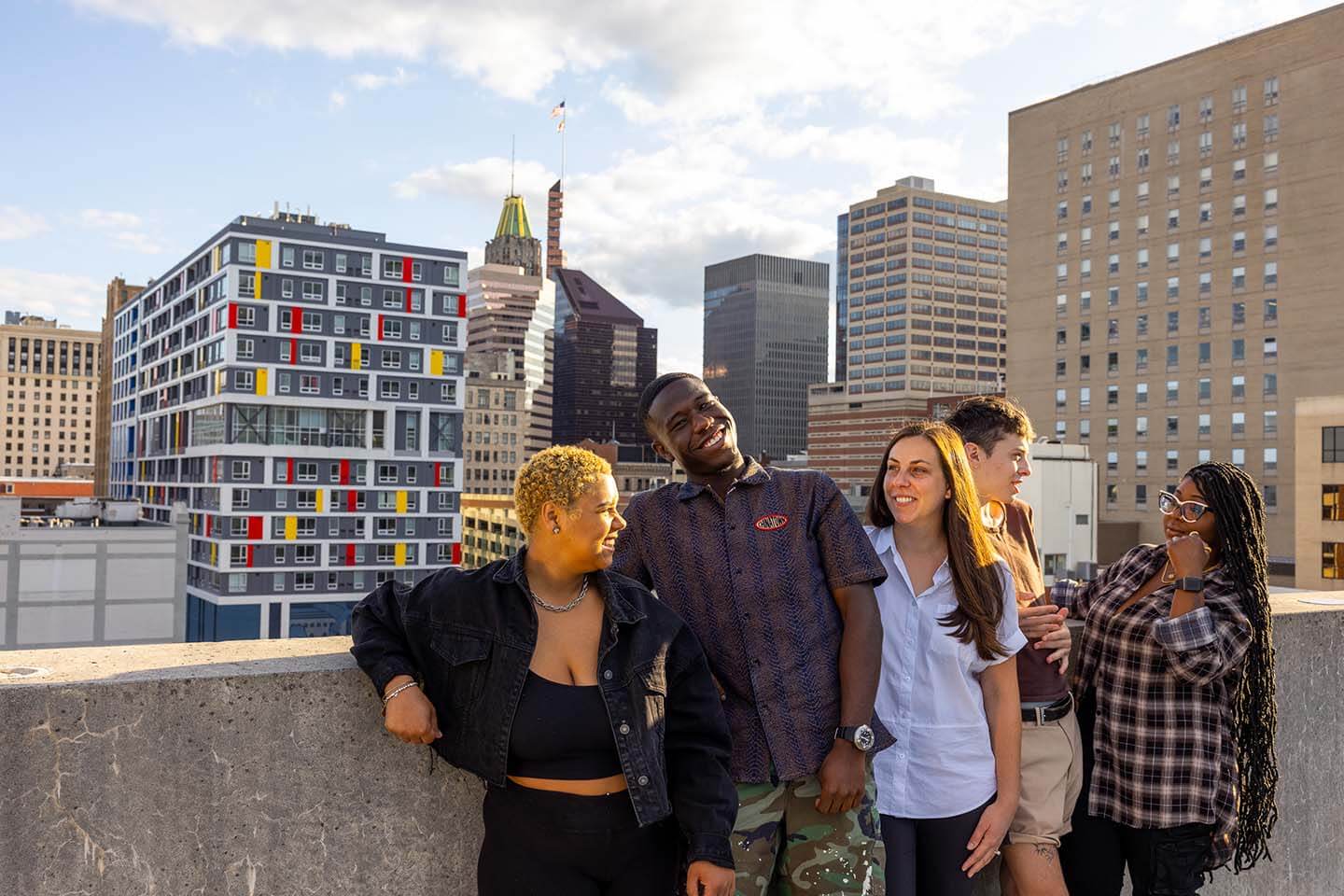 Group of young adults against the Baltimore City skyline.