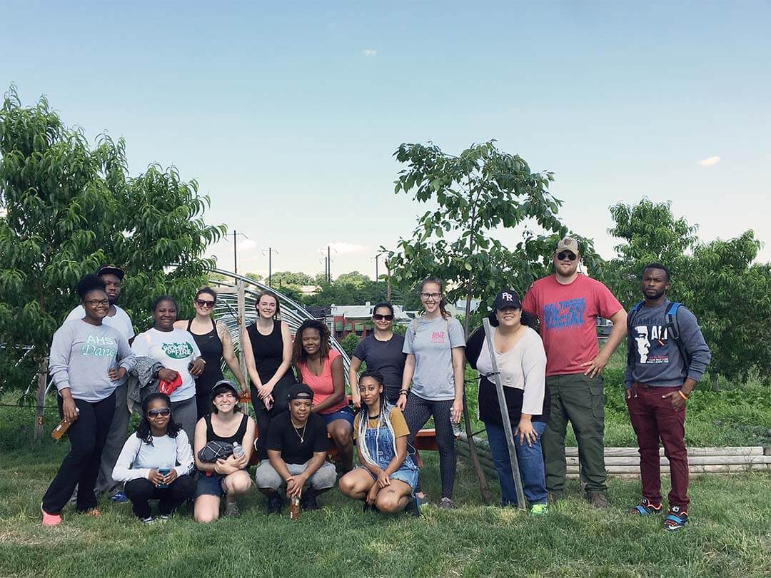 Group posing in front of trees.