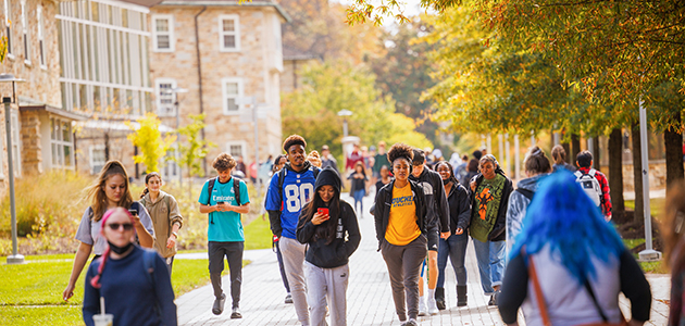 Students walk on a campus. 