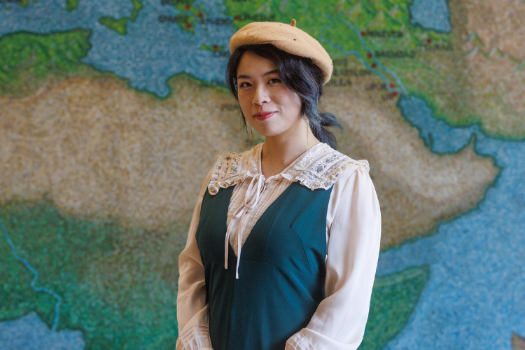 Portrait of person in front of a map.