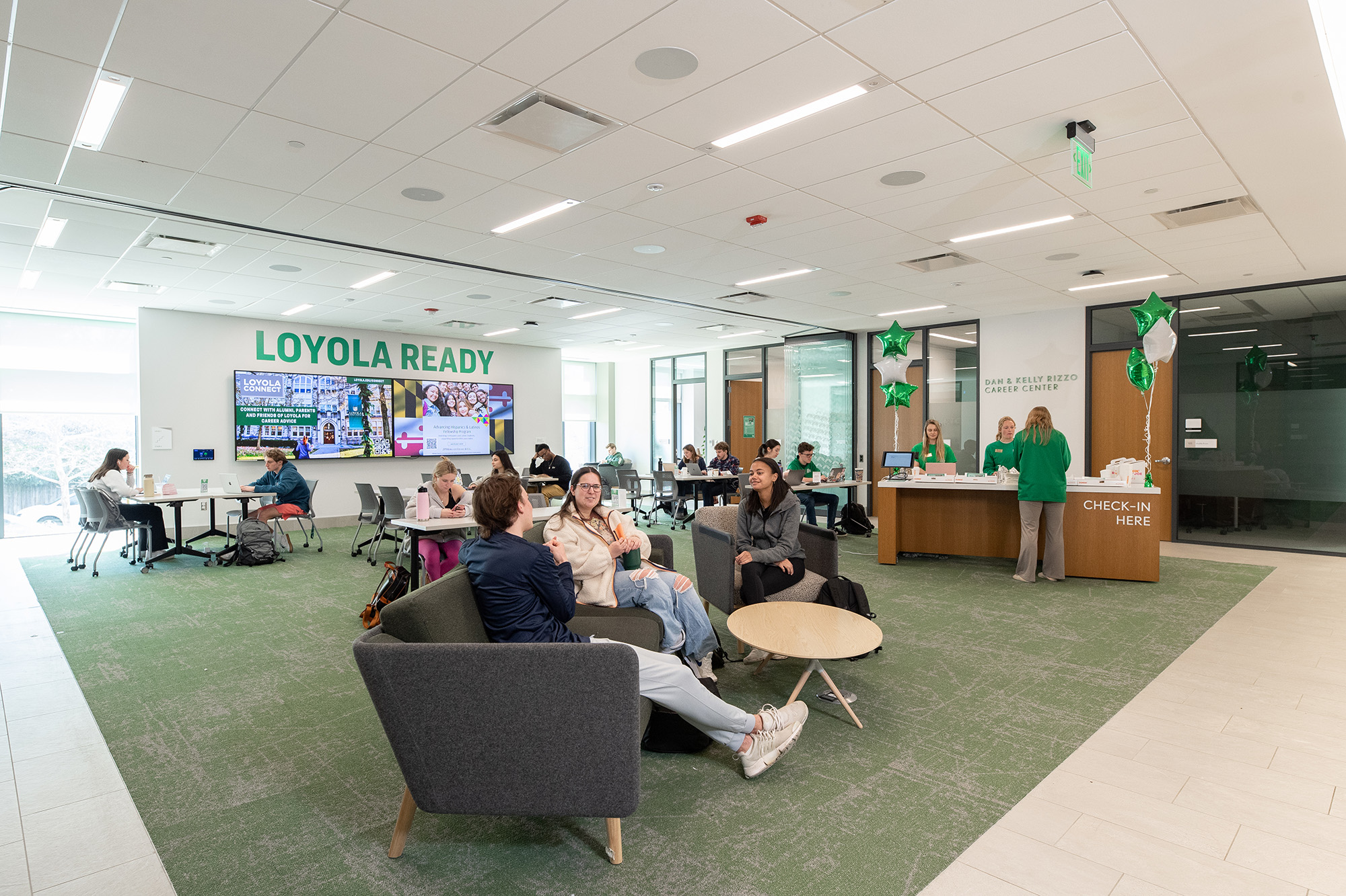 Students sitting in and working in the Loyola University Maryland lounge.