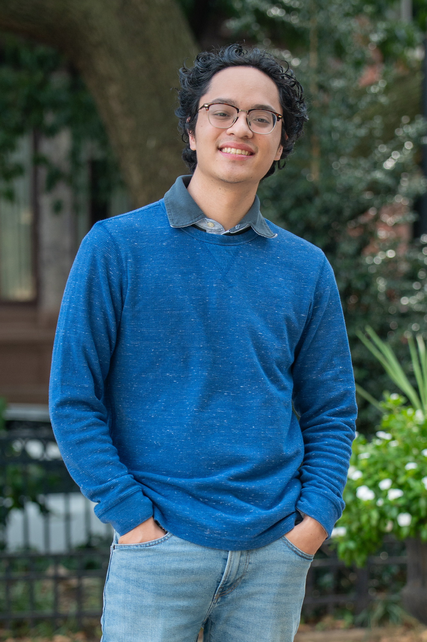 A student poses in front of a public park.