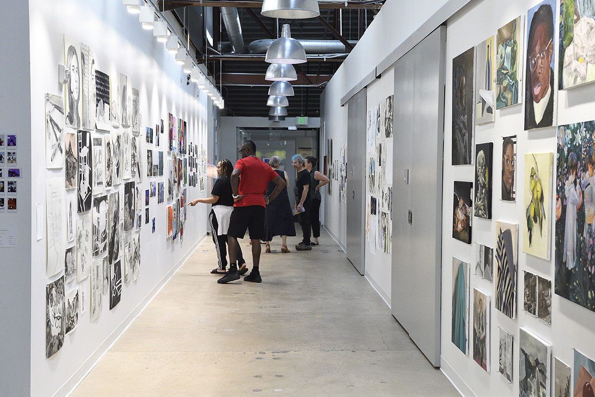 Students on the Hopkins campus looking at an art gallery's hallway.