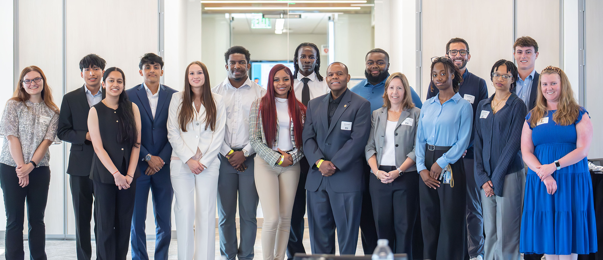 A group of people posing for a photo and smiling.